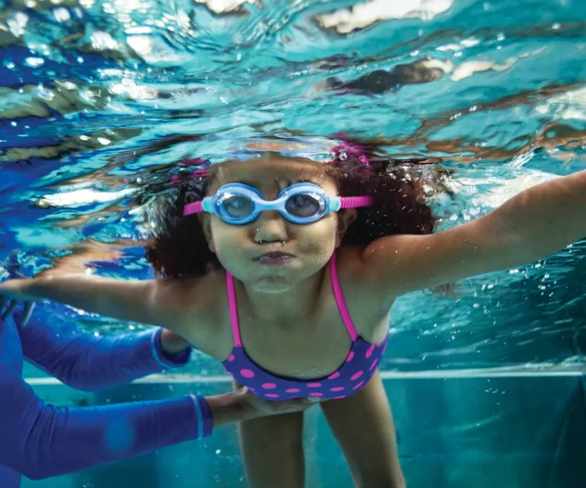 Child learning to swim 